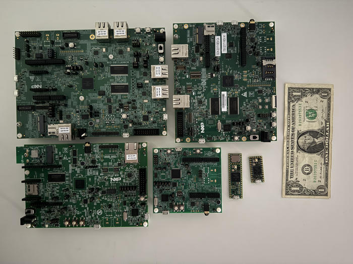 A collection of i.MX RT development boards. US dollar for scale.